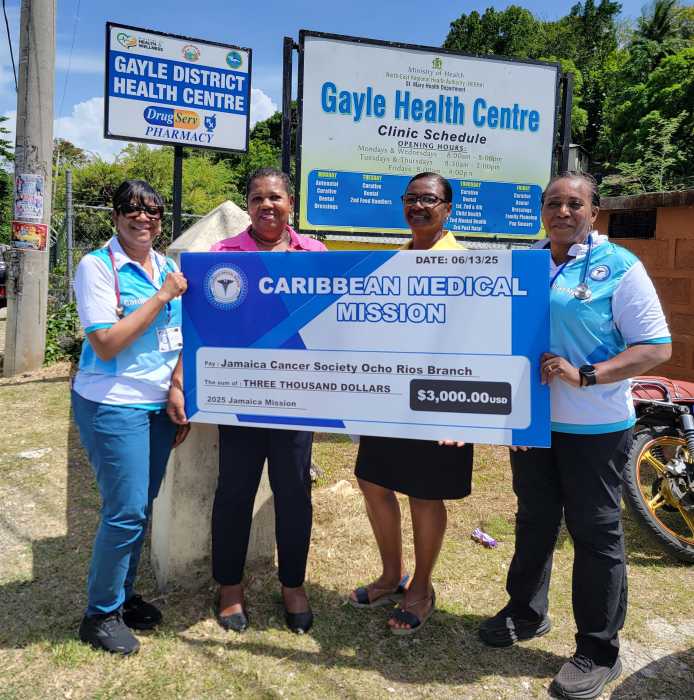 From left, Dr. Natasha Telesford, VP of CMM; Brenda Brown, volunteer; Daidrey DaSilva, Jamaica Cancer Society; and Dr. Donna Hutton-Cassie, CMM president, present a check at the Jamaica Cancer Society office in St. Ann, Jamaica.