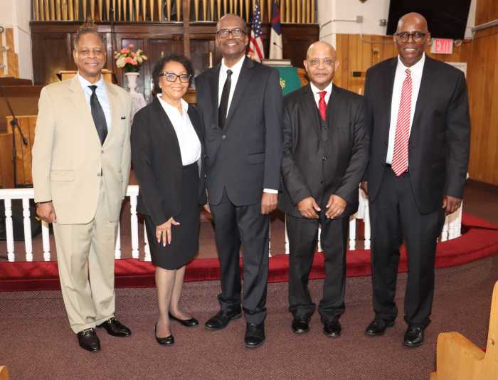 Rev. Lawrence Craig, left; Pastor the Rev. Roger Jackson, right; FSUMC Men's Group President Bro. Shaphat Jack, fourth from left; pose with Bro. Jeffrey Adolphus, who played the drums during Worship Service, with his wife, Barbara.