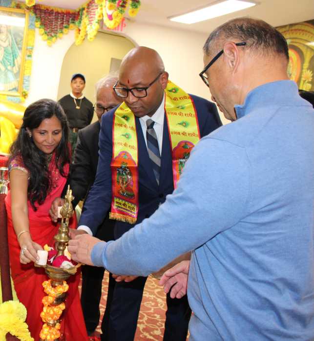 A religious leader, left, joins Borough President Donovan Richards Jr., and NYS Senator John C. Liu in lighting the symbolic Diya at the Hindu Center on Kissena Blvd, Queens, on Oct. 16, in celebration of Diwali - a Festival of Lights.
