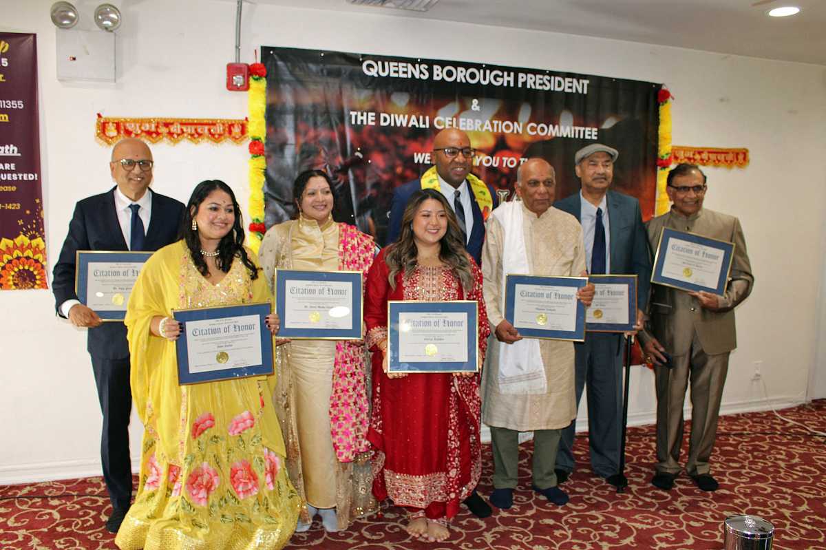 Queens Borough President Donovan Richards Jr. hosted a spirited Diwali celebration at the Kissena Hindu Center in Queens, and presented Citation of Honor to community leaders who have made significant contributions throughout the borough. From left are Dr. Vipul Patel, Sami Sarkar, Guyanese-born Dr. Sharla Madho-Khargi, Dr. Shreeya Tuladhar, Queens Borough President Donovan Richards Jr. (in back), Nagasser Ramgarib, Ashif Ahmed, and Rasik Sanghavi. The event was held on Oct. 16.