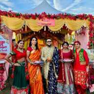 Mohamed Q. Amin, third from left, founder/president of the Caribbean Equality Project, surrounded by members, in front of their colorful ornate booth at the Annual Diwali Festival on Oct. 18, in Smokey Park, Queens.