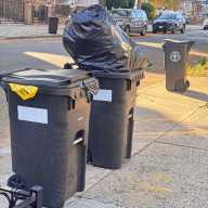 Residents set out compost bins for collection under New York City’s expanded sanitation program.
