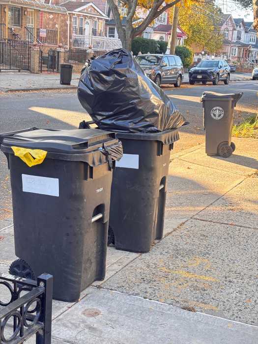 Residents set out compost bins for collection under New York City’s expanded sanitation program.