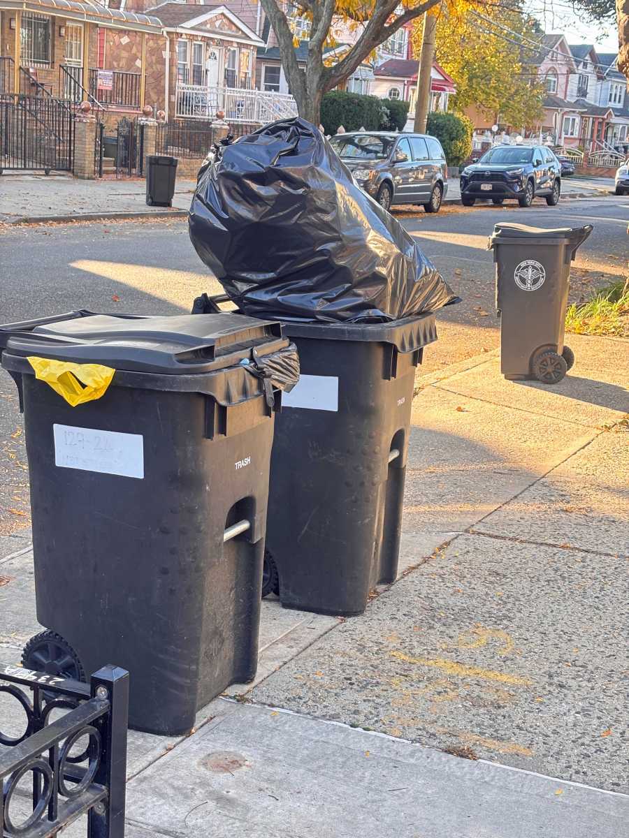 Residents set out compost bins for collection under New York City’s expanded sanitation program.