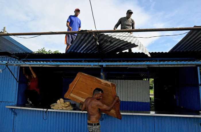 People prepare for the arrival of Hurricane Melissa in Santiago de Cuba, Cuba, Oct. 27, 2025.