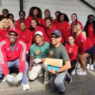 Track & Field Athletes of St. John's University in Queens, strike a pose on Saturday, Sept. 27 - "University Service Day" at the newly branded Community Food Pantry Inc. in Richmond Hill. The ladies and coaches volunteered, bagging and serving nutritious meals to hundreds of residents in two sessions. From left, stooping front, are Coach Desmond Robinson, and Board Members of Community Food Pantry, Roger Gary, and Tony Singh.