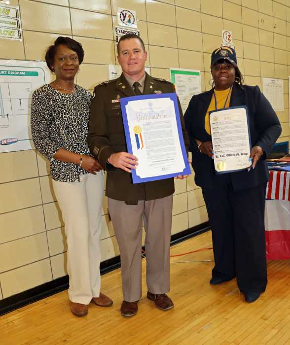US Army NYC Recruiting Battalion Commander, Lt. Colonel Oliver Karp holds proclamation, assisted by Dr. Cleopatra Brown, chairperson, CB #16 Veterans Affairs Committee, to his left, who also holds citation; and MC Margaret Brewer, chairperson, CB# 16.