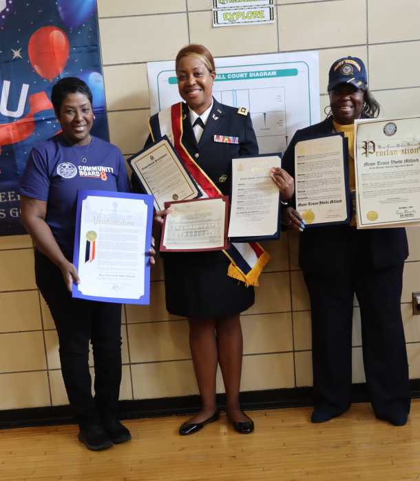 Featured speaker Major (Ret.) Tracee Y. Millard, Esq., center, receives proclamations and citations assisted by community board members.