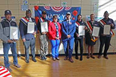 Veteran honorees display proclamation with New York State Assembly Member Stefani L. Zinerman, center, and NYC Department of Veterans' Services Commissioner James W. Hendon, to her immediate left.