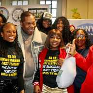 From left, Council Member Rita Joseph, PS 135 Superintendent Celeste Terry, Principal of PS 135 Mrs. Mcrae, front, Assembly Member Monique Chandler-Waterman, Busta Rhymes, Dr. Meda Leacock, and others helping the Blessings Don't Stop singer distribute turkeys on Nov.22, 2025 at PS 135.