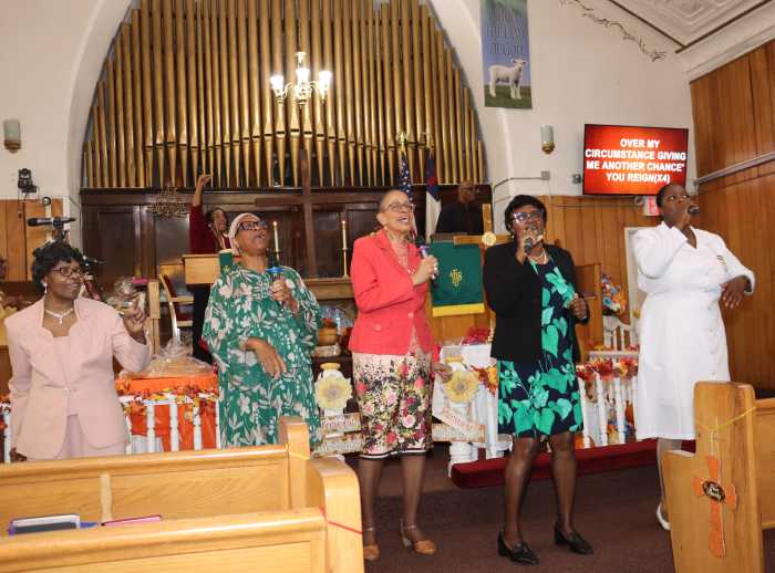 The Praise and Worship Team sings "Give Him Glory for He's the King of Kings.”