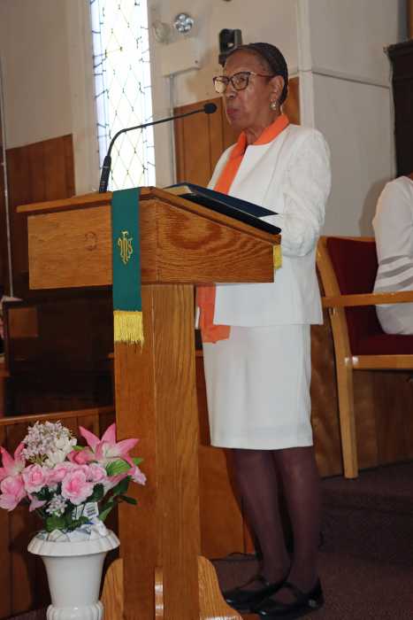 Sis. Linda Brown reads the church's history.