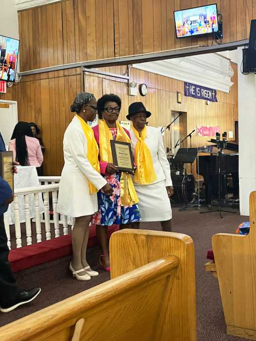Sis. Desma King receives award from Sis. Marlene Ferguson, left, and Sis. Doreen Thomas.