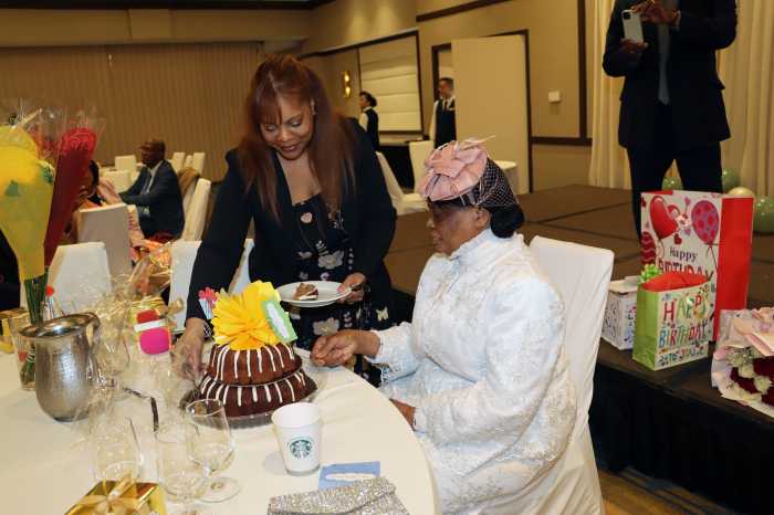 Caroline Soleyn, Pastor Neithe E. Soleyn's last daughter, assists her mom after cutting the birthday cake.
