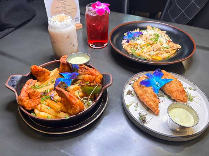 A vibrant serving of Rasta pasta, empanadas, fried shrimp with fries, and Déjà Brew Café’s signature hot and cold beverages showcase the restaurant’s Caribbean fusion menu made entirely from scratch.