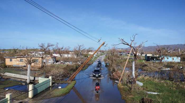 Drone view of vehicles driving along a flooded road, in the aftermath of Hurricane Melissa, in Black River, Jamaica, Nov. 2, 2025.