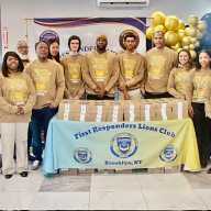 Members and officers of the First Responders Lions and Leos clubs pose for a photo in Liberty Bible Fellowship Church lobby, after prayers. They distributed pre-Thanksgiving pies to worshipers on Nov. 17, 2025.