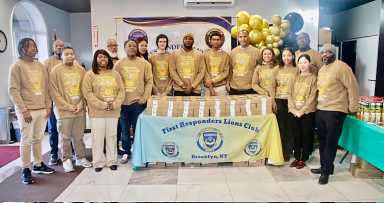 Members and officers of the First Responders Lions and Leos clubs pose for a photo in Liberty Bible Fellowship Church lobby, after prayers. They distributed pre-Thanksgiving pies to worshipers on Nov. 17, 2025.