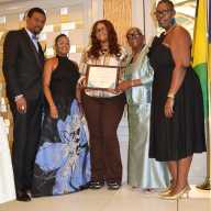 Laniya Simmons, center, receives scholarship award, flanked by, L-R: Consul General to the US Rondy "Luta" McIntosh; his wife, Semone; Scholarship Committee Chairperson Celia Bramble; and Featured Speaker Sherrill-Ann Mason-Haywood.