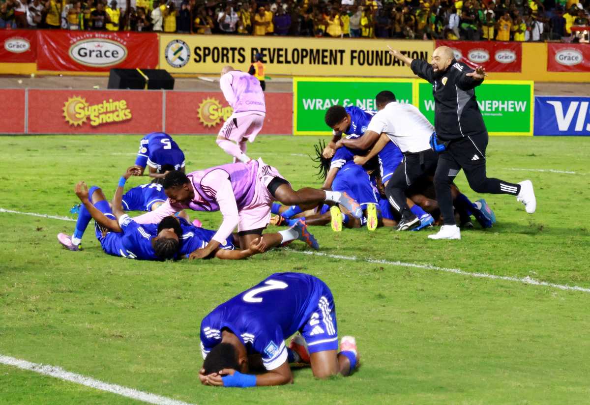 Curacao coach Dean Gorre and players celebrate after they qualify for the World Cup during their match against Jamaica at the National Stadium Independence Park, Kingston, Jamaica on Nov. 18, 2025.