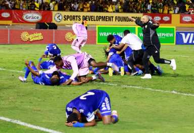 Curacao coach Dean Gorre and players celebrate after they qualify for the World Cup during their match against Jamaica at the National Stadium Independence Park, Kingston, Jamaica on Nov. 18, 2025.