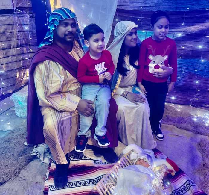 Mary and Joseph, welcome arrivals to the manger where Baby Jesus lay in a crib dressed in swaddling clothes. This Nativity station attracted children, and adults alike at a Christmas Village celebration at Liberty Bible Fellowship Church, in Ozone Park Queens, on Friday, December 5.