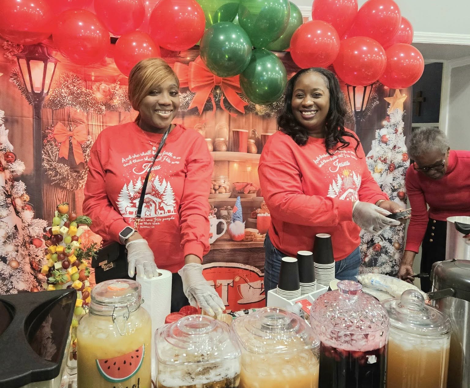 Santa's Elves welcomed celebrants to Liberty Bible Fellowship Church Christmas Village with big smiles and homemade drinks of sorrel, ginger beer, mauby, golden apple juice, and treats, as they entered the lobby area of the sanctuary.