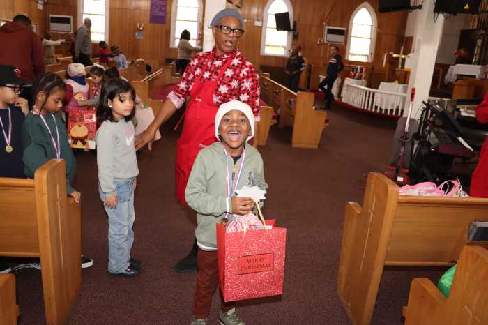 A child is all smiles after receiving a gift.