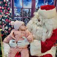 A child looks at Santa Claus with wonder, having seen him for the first time.