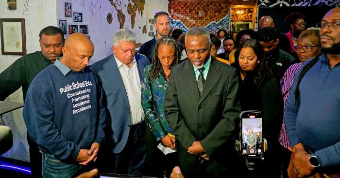 Dalton Robinson, center, leads prayers, flanked by elected officials, including Brooklyn DA Eric Gonzalez, third from left.
