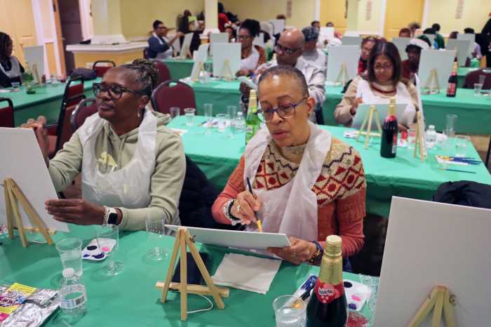 Irene Braithwaite, left, foreground, and Patricia Senhouse focus intensely on painting.