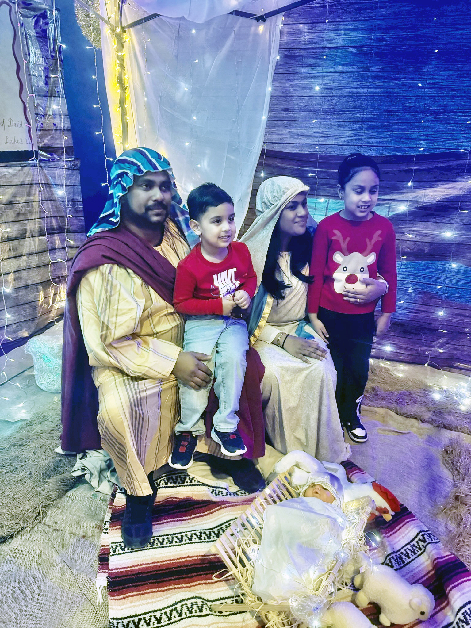 Mary and Joseph, welcome arrivals to the manger where Baby Jesus lay in a crib dressed in swaddling clothes. This Nativity station attracted children, and adults alike at a Christmas Village celebration at Liberty Bible Fellowship Church, in Ozone Park Queens, on Friday, Dec. 5, 2025.