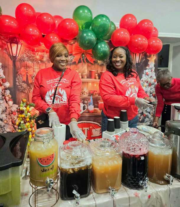 Santa's Elves welcomed celebrants to Liberty Bible Fellowship Church Christmas Village, with big smiles, and homemade drinks of Sorrel, Ginger Beer, Mauby, Golden Apple juice, and treats, as they entered the lobby area of the sanctuary, on Friday, Dec. 5, 2025.