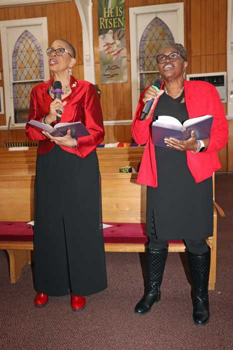 Patricia Senhouse, left, and Irlene Braithwaite sing "O Little Town of Bethlehem.”