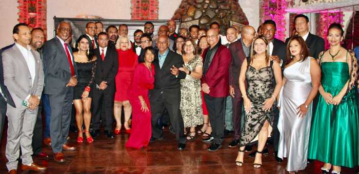 Members of International Center of Democracy, with President Mohamed Irfaan Ali, (eight in the back) next to Consul General to New York Ambassador Michael D. Brotherson, and Fazel Joe Yussuf, at (ICD) Christmas social, on Dec.13, 2025 in Queens.