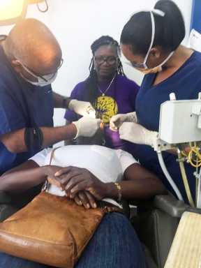 New York Board-Certified Oral and Maxillofacial Surgeon Dr. Dwight Williams (l) attending to a patient on a recent dental mission to Jamaica.