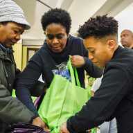 Crystal Hudson, right, assists with a Thanksgiving bag.