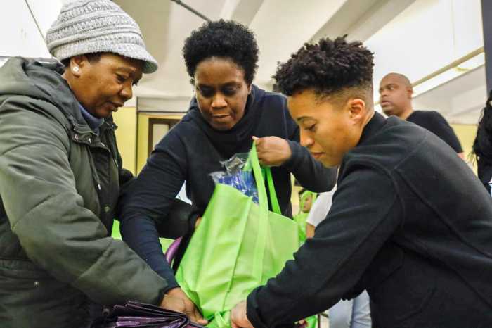 Crystal Hudson, right, assists with a Thanksgiving bag.