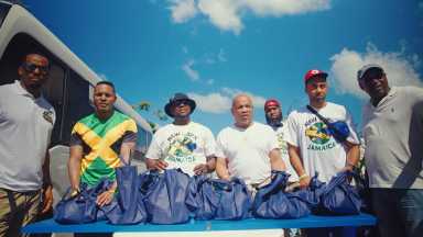 From left NY State Assembly Member Noah Burroughs, US Representative, Ritchie Torres, NY City Council Member, Kevin Riley, Speaker of the NY State Assembly, Carl Heastie., Assembly Member, Brian Cunningham (in background), NY State Senator, Jamaal Bailey and Mayor of Savanna-La-Mar, Danee Delancy, with prepared packages to hand out to residents in Savanna-La-Mar, Jamaica.
