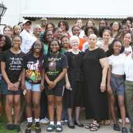 Current members and alumni of the BSU/AHCCC, along with faculty, staff, and the Sisters of Saint Joseph (CSJ), gather in front of the original convent — once home to the CSJ educators who led TMLA for decades — during the May 2025 TMLA Black Student Union / African Heritage and Caribbean Culture Club five-year anniversary celebration.