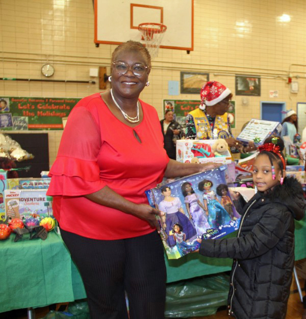 Sen. Persaud gives a gift to a child.