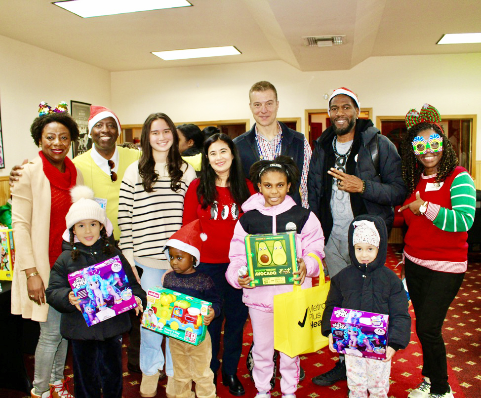 From left, Immigration Attorney Melnia Cordis, host of the Reset Talk Show, JR Giddings, family, Maria Weigand, Mrs. Sharon Weigand, Audiologist, SUNY Downstate Hospital, John Weigand, Public Advocate Jumaane Willliams, volunteer Claire Patterson-Monah, and children with their toys, at the 2nd Annual toy giveaway, hosted by the Reset Talk Show, at Reflections Church, on Dec. 13, 2025.