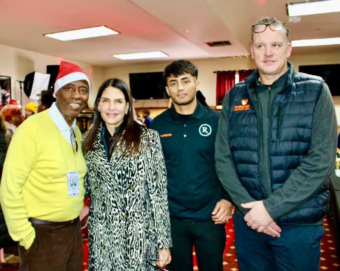 JR Giddings, host of the Reset Talk Show, thank Lisa Lonuzzi owner of United Beverage Distributors Corporation, Director of operations, Popeyes Kings Highway, Karan Kaknia, and VP Operations, Liberty Restaurant Popeyes, Daniel Di Chiara, donors of the 2nd Annual Toy Giveaway, on Dec. 13, at Reflections Church on Utica Avenue.