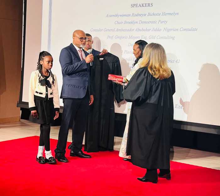 Judge Chidi Eze reciting the oath of office in the presence of his family.