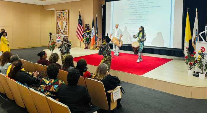 Members of the audience enjoying a drum performance.
