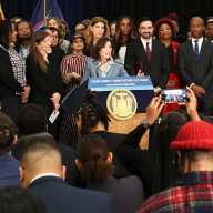 Governor Kathy Hochul speaking on the announcement with myriad state and city elected officials.