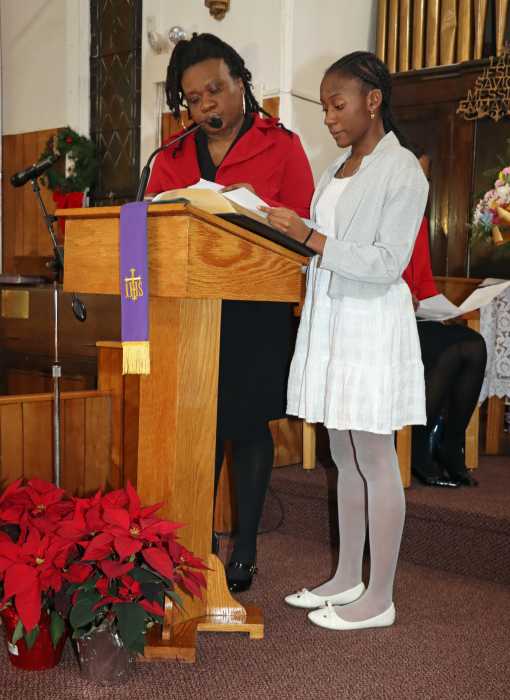 Ava Providence and daughter, Angelica Nedd, reads a selection during the lighting of the Advent Candles.