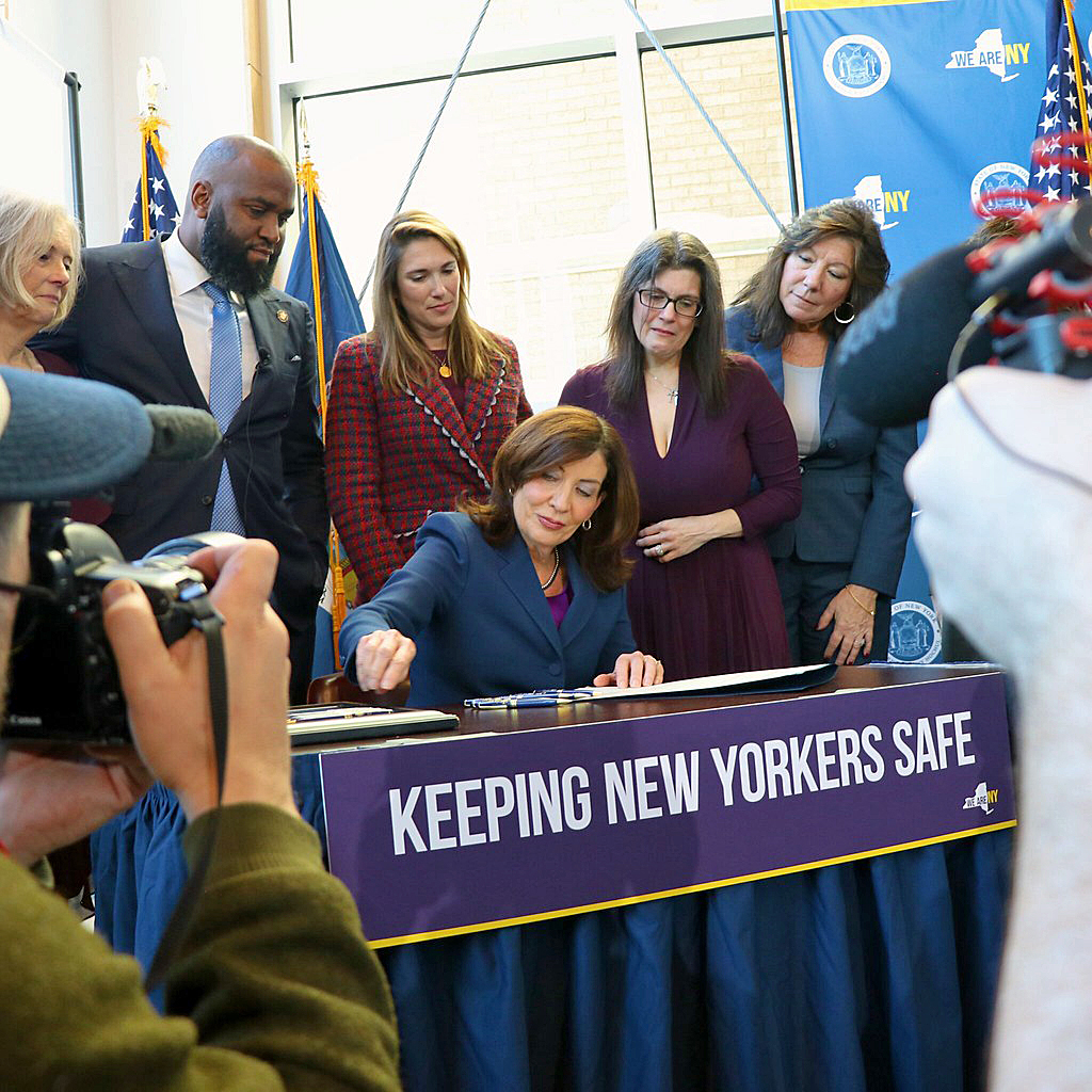 NY Gov. Kathy Hochul signs Melanie’s Law into effect, flanked by Assembly Member Brian Cunningham, second from left, and others.