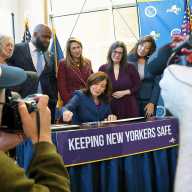NY Gov. Kathy Hochul signs Melanie’s Law into effect, flanked by Assembly Member Brian Cunningham, second from left, and others.