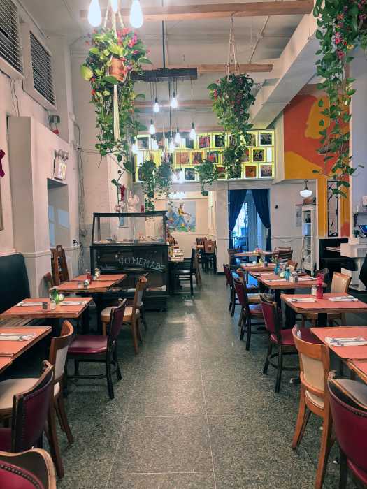 A warmly lit dining room at Bar Manje blends polished design with an intimate neighborhood feel, reflecting chef Kingsley John’s approach to Caribbean-inspired cuisine rooted in connection, comfort and hospitality.